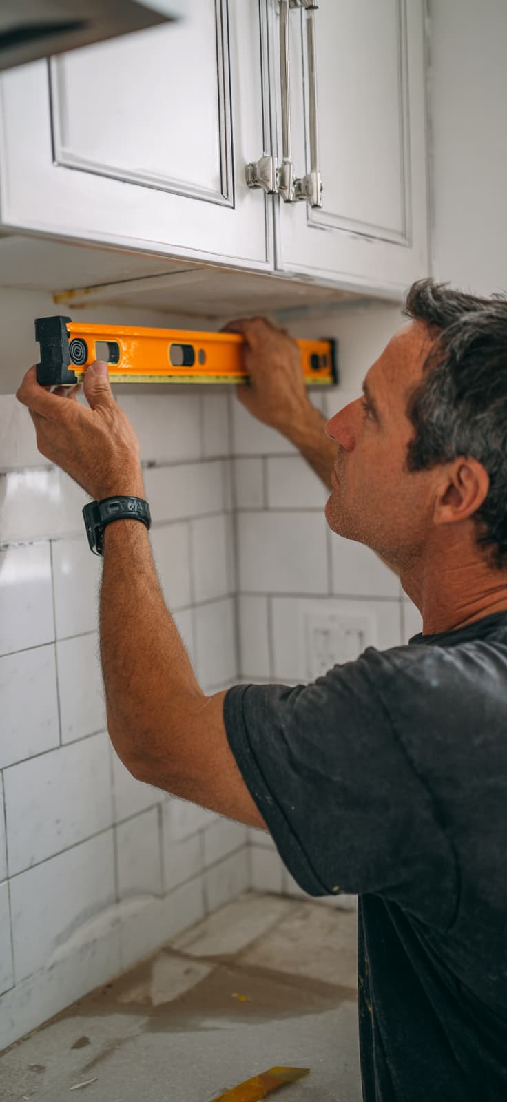 Person using level tool in kitchen